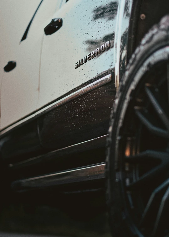 the wheels and rims of a silver car with black powder on it