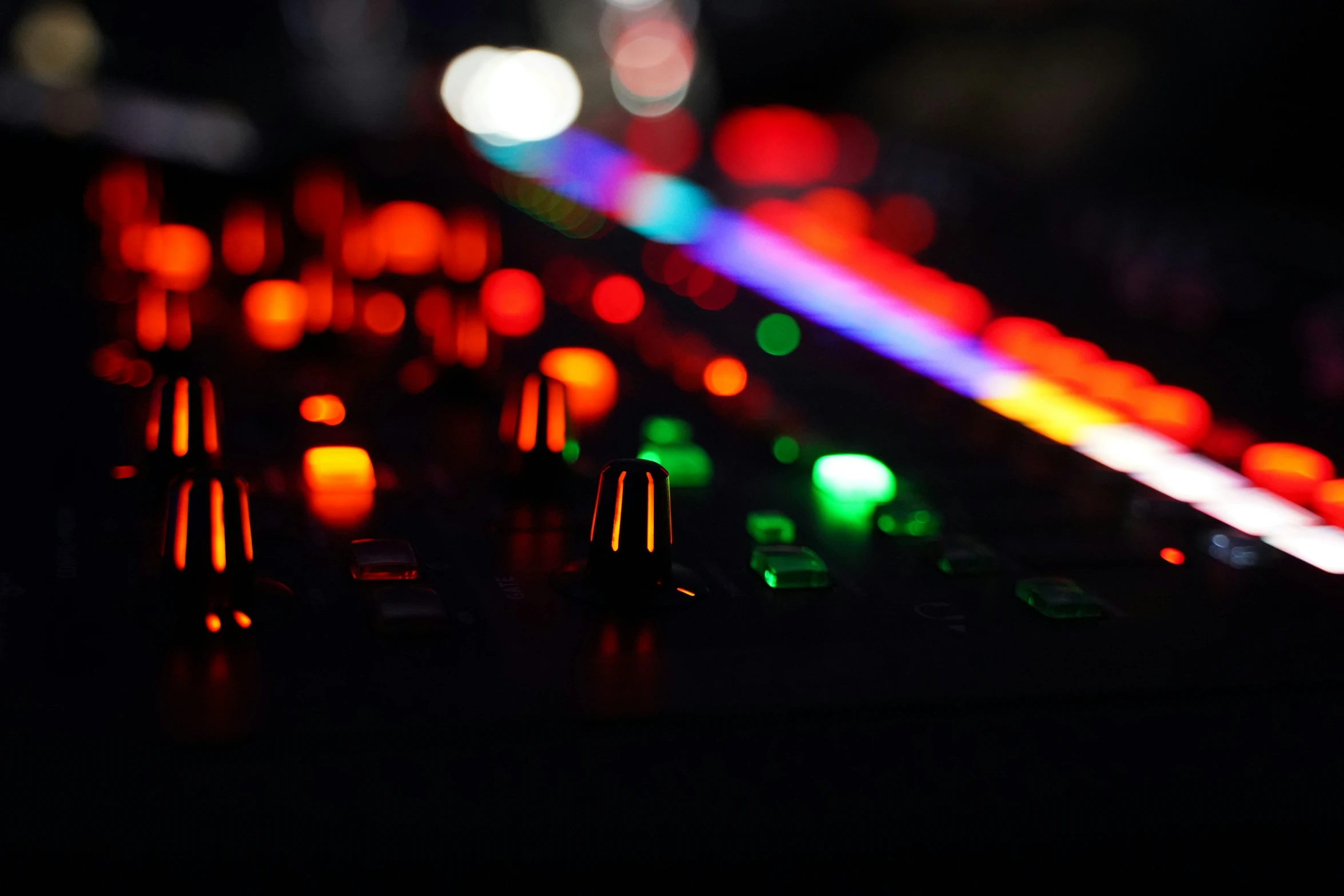 a dj mixing station that has brightly colored lights