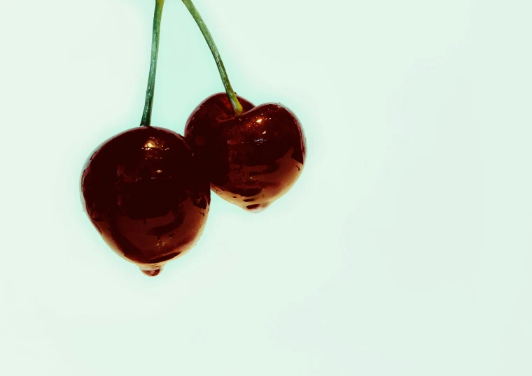 two cherries on top of each other with one another