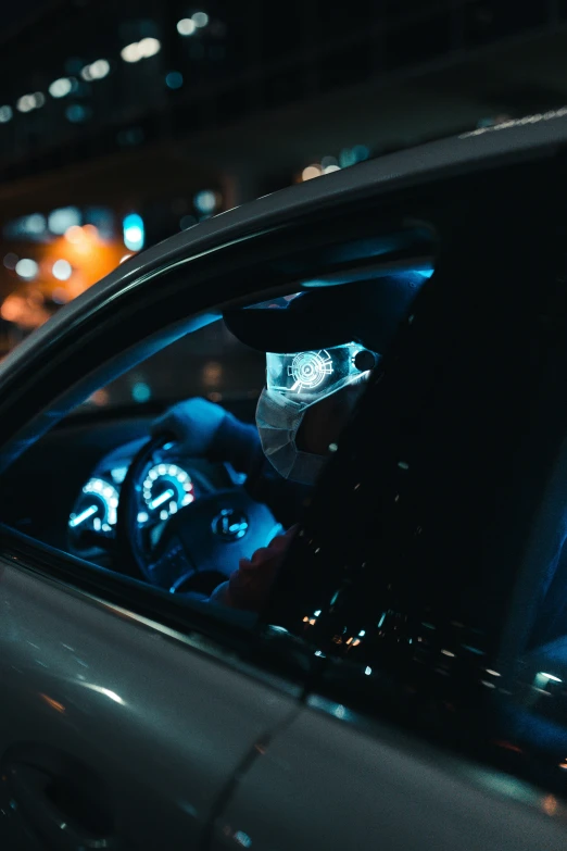 a view from inside the car at night showing a traffic light that is on