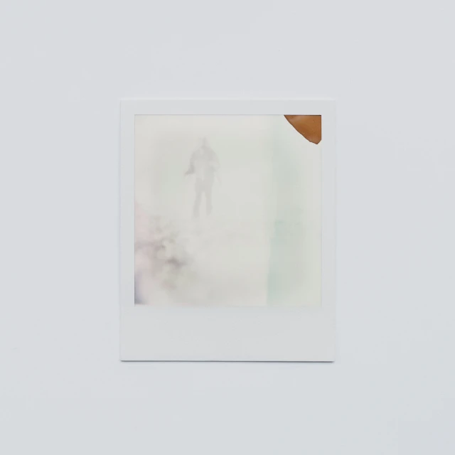 a polaroid po hanging up in a white room