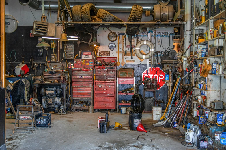 a room full of various tools and cabinets with walls above