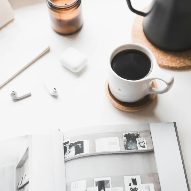 a coffee cup with a book next to it