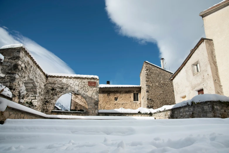 the wall and door of a building covered in snow