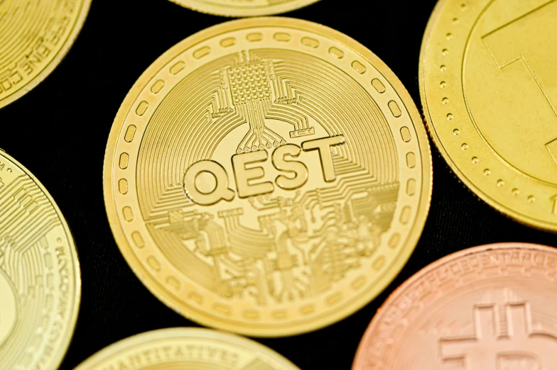 several coins, featuring the word quest, are pictured