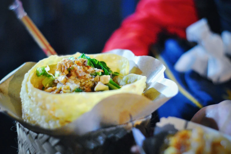 a dish with meat and vegetables in it sitting on a table