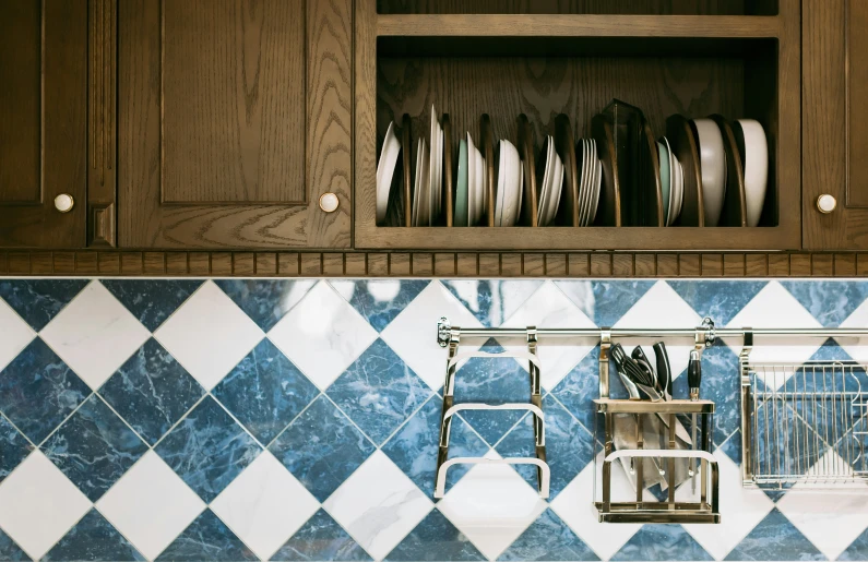 a kitchen with wooden cabinets and plates hanging on the wall