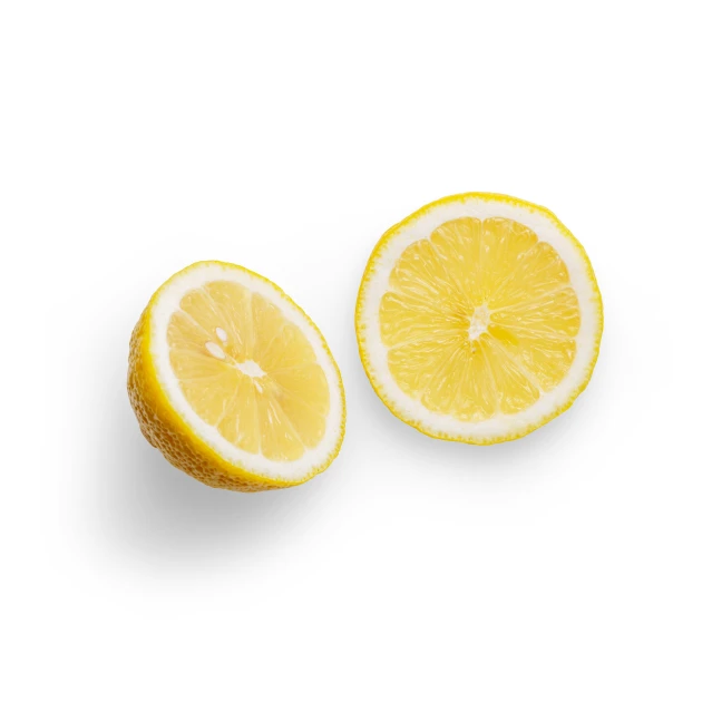 two slices of lemon on a white surface