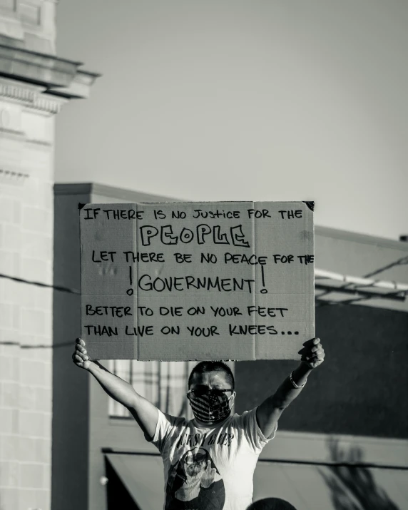 a man holding up a sign that reads, there is no doing for the people, let there be no peace for government