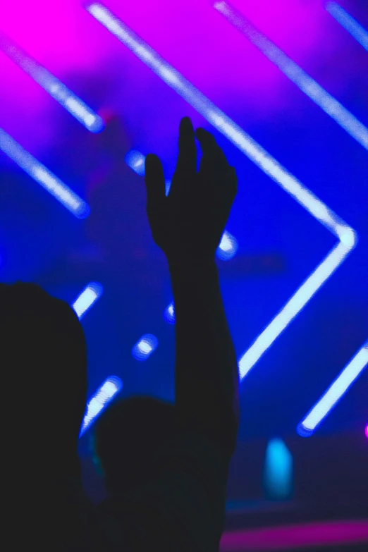 the view of someone doing soing in front of a brightly lit stage