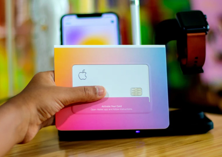 someone holding up an apple card in front of the camera