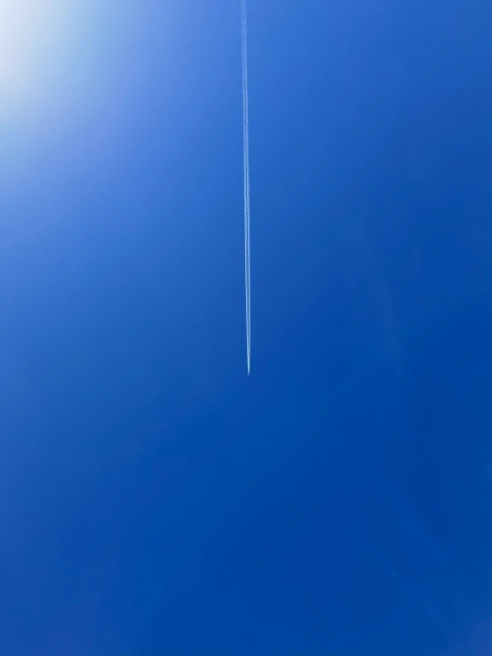 a plane is flying overhead in the blue sky