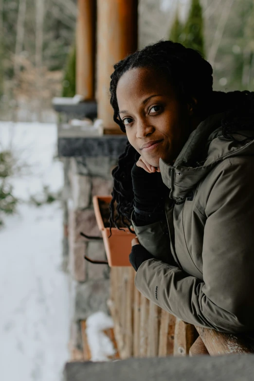 a woman standing on top of a wooden porch