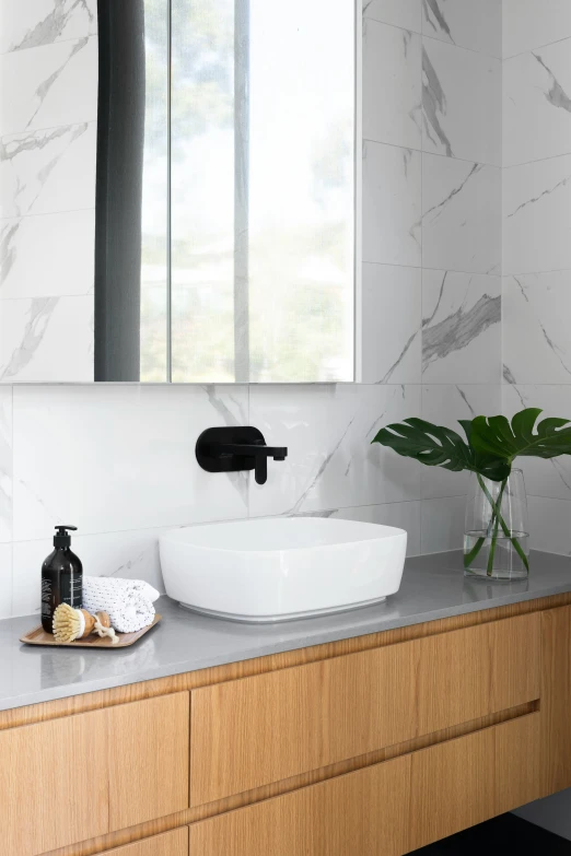 the bathroom vanity is decorated with modern black fixtures