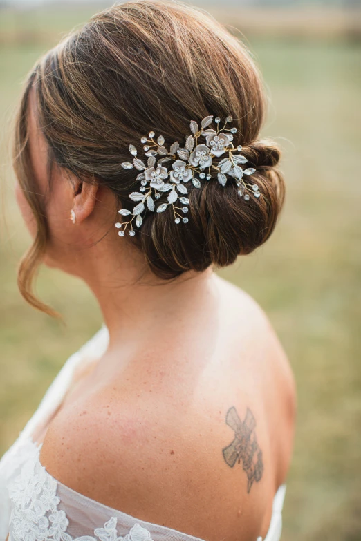 a woman in a wedding dress looking back at her hair comb