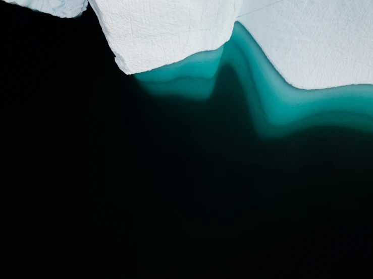 an iceberg that is floating in some water