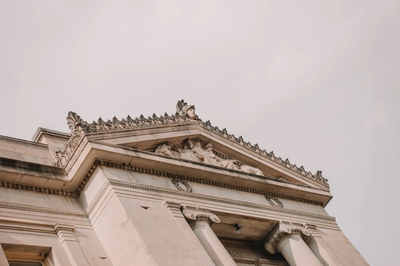 a very tall building with many ornate carvings on the top