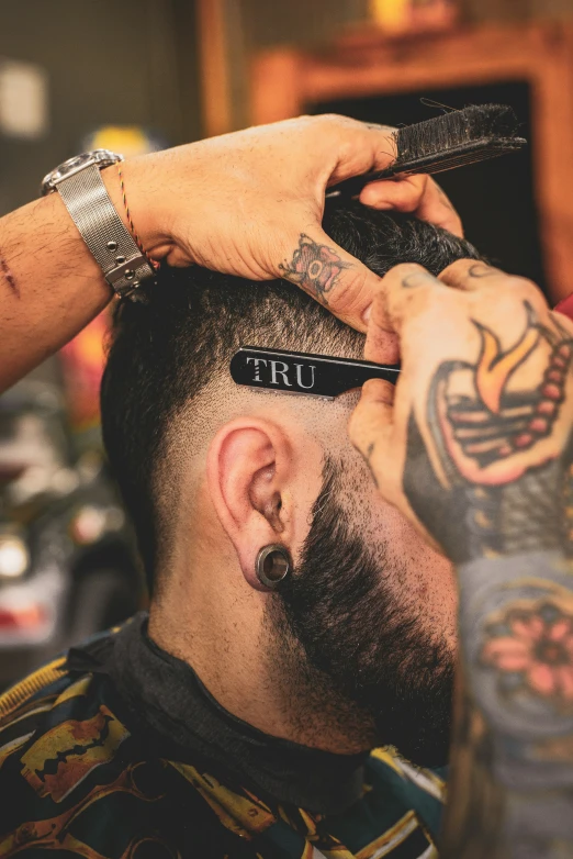 a barber cuts the beard of a man