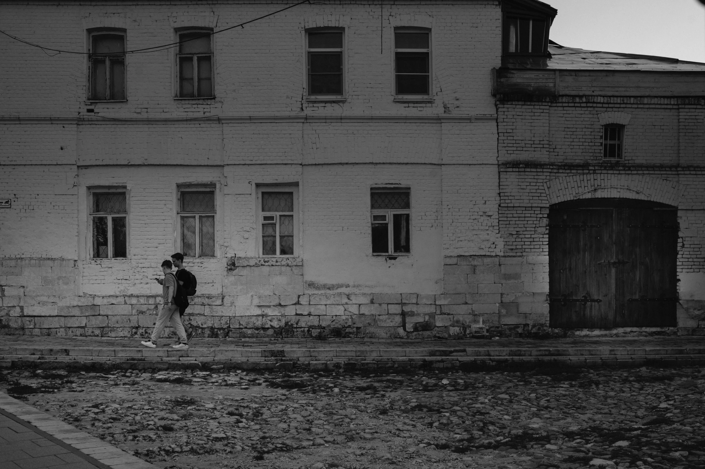 a couple is standing in front of an old building