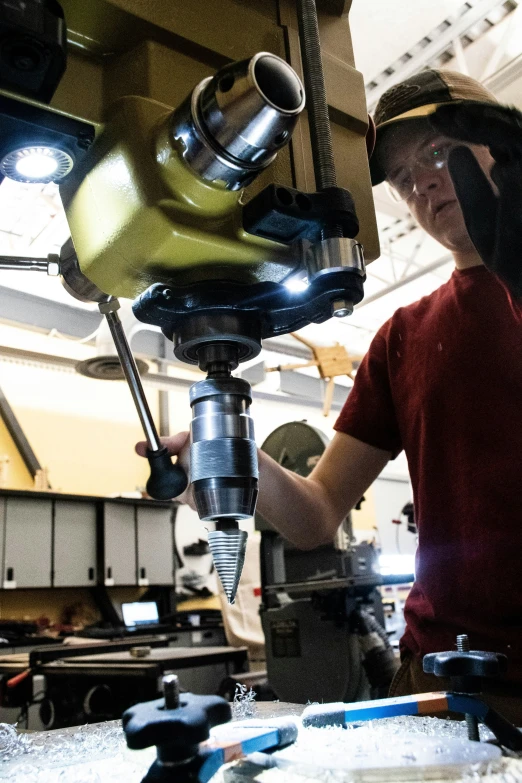 a man is working on soing in a machine shop