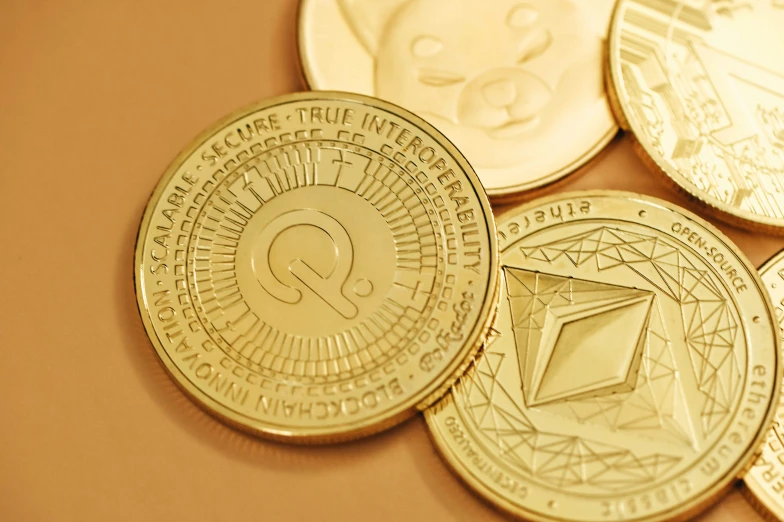 five golden crypt coin laying on top of each other