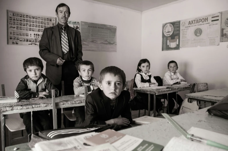 a group of young children sitting in classroom