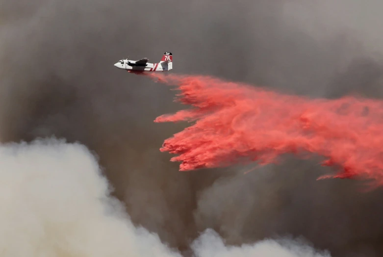 a red fire hydrant pouring water onto the sky