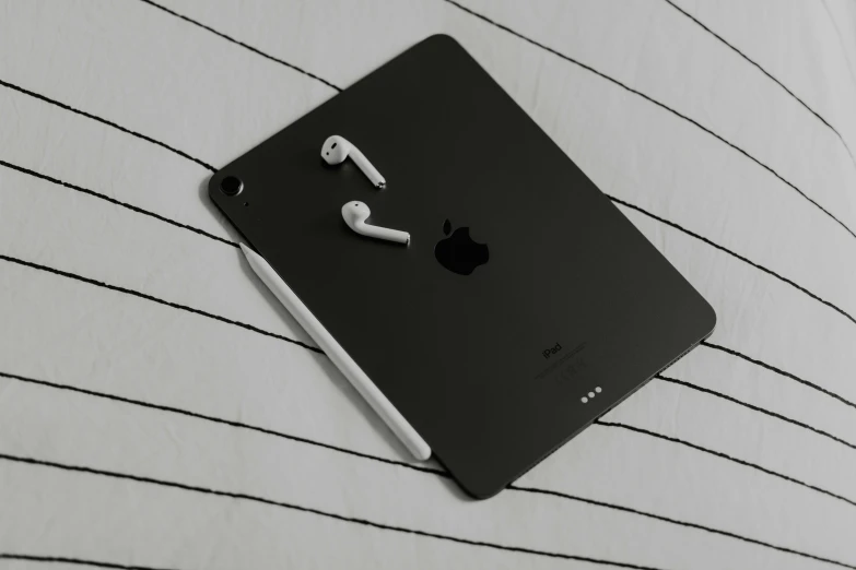 an apple ipad with headphones on the side of it