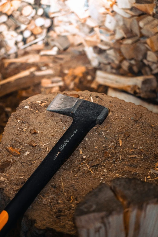 a knife on top of a rock near a pile of wood