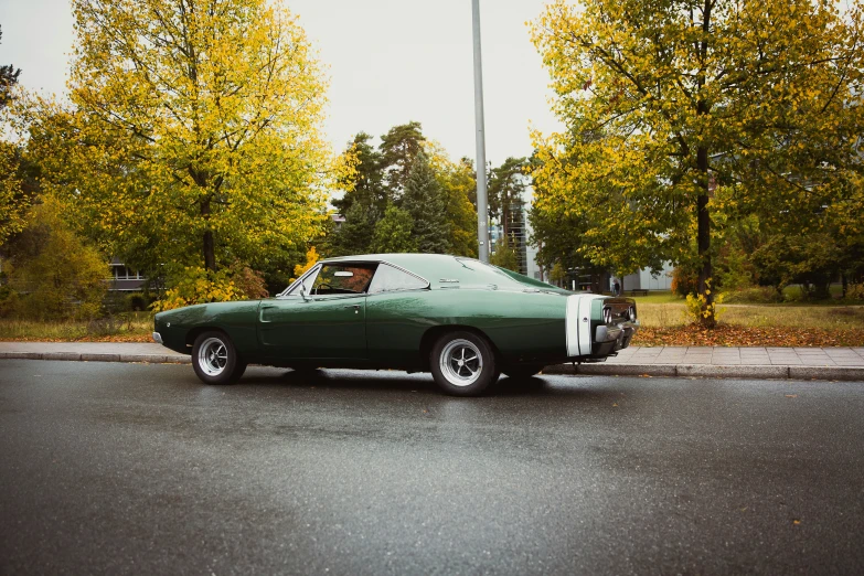 a green sports car is parked on a street