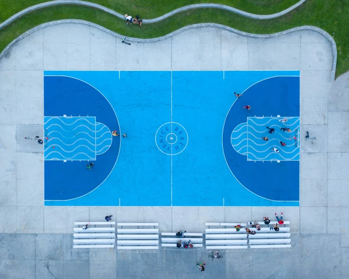 people are seen from above as they play with water near a park