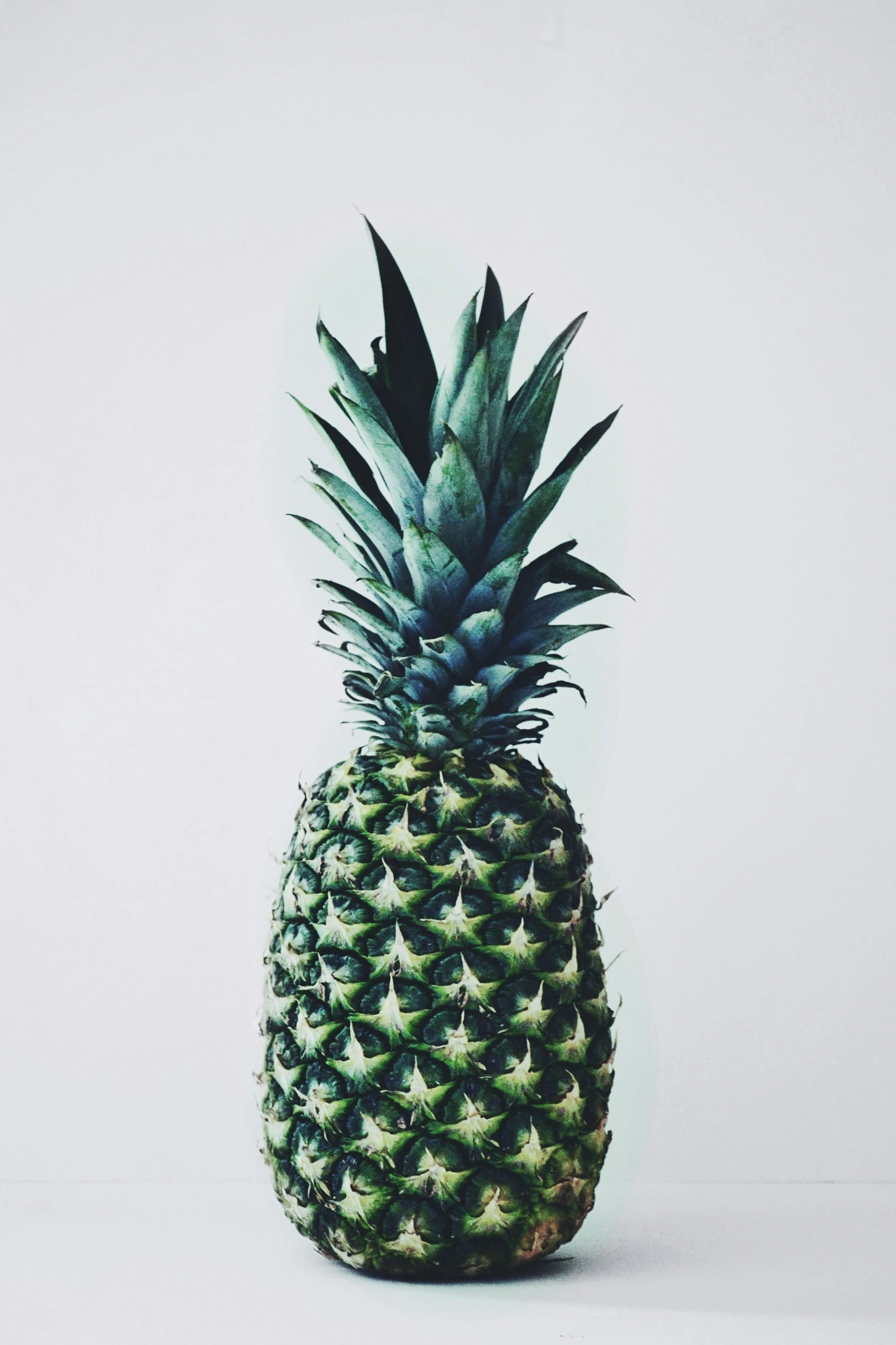 a close up of a pineapple on a white table