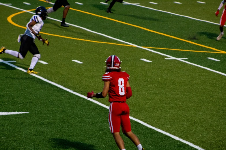 football players running and blocking during a game