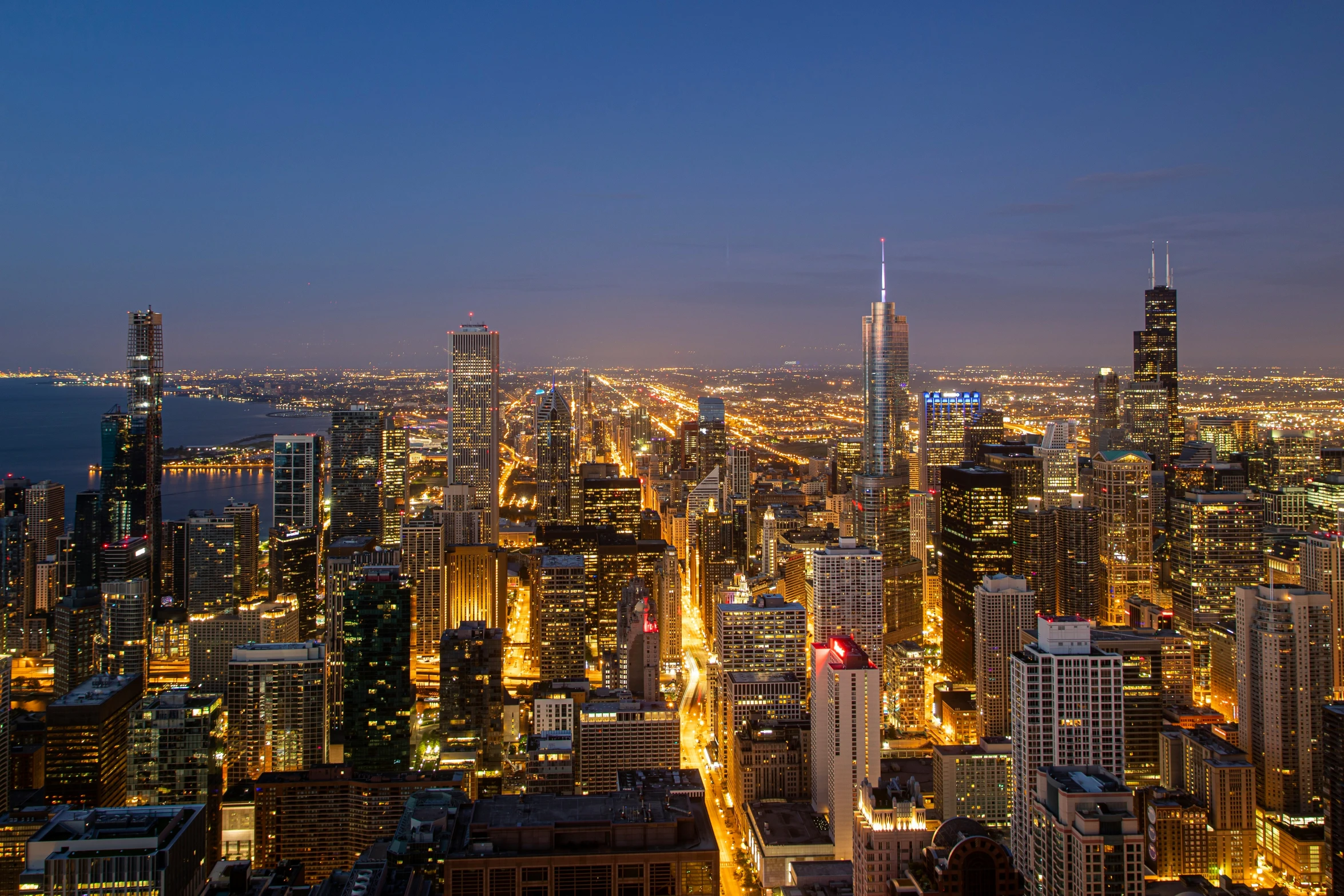 cityscape of huge buildings at night in large city