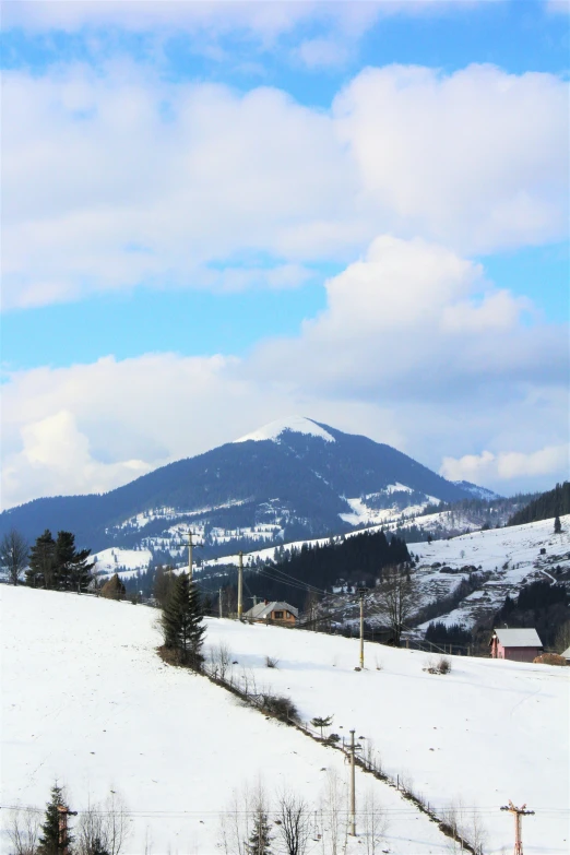 snow covered landscape with ski equipment and mountains