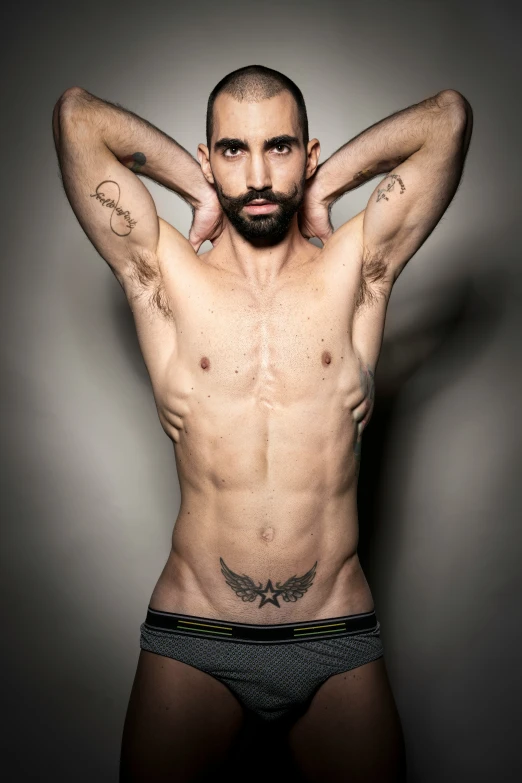 a shirtless male in a underwear is posing for the camera
