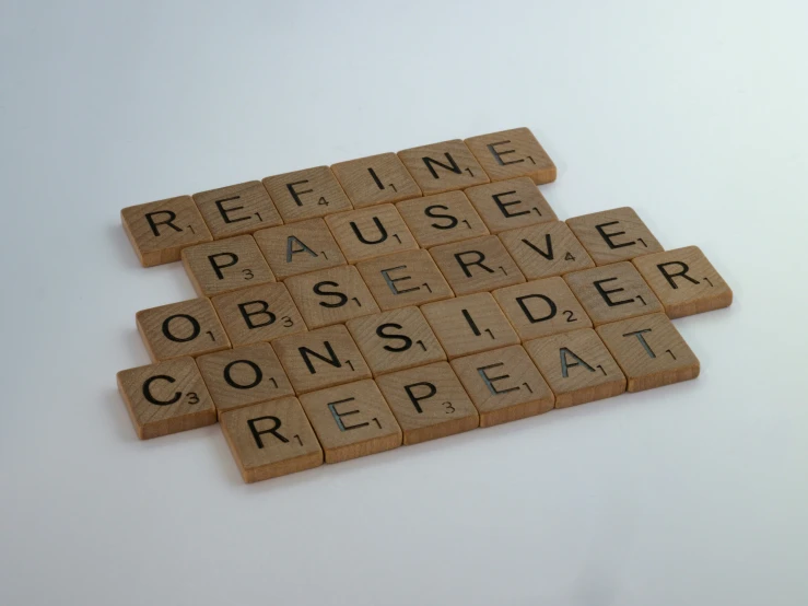 two scrabble tiles sitting on top of each other