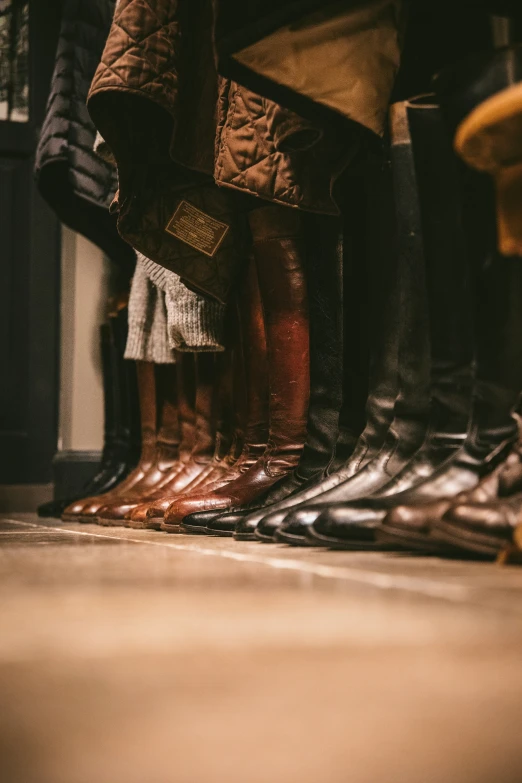 the bottom half of people standing on shoes in the middle of a room