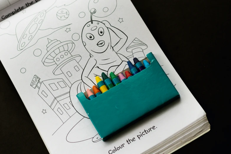 colored pencils with an eraser in front of coloring pages