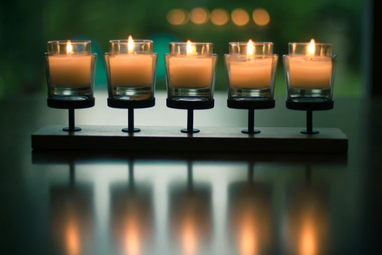 some candles are lined up near each other