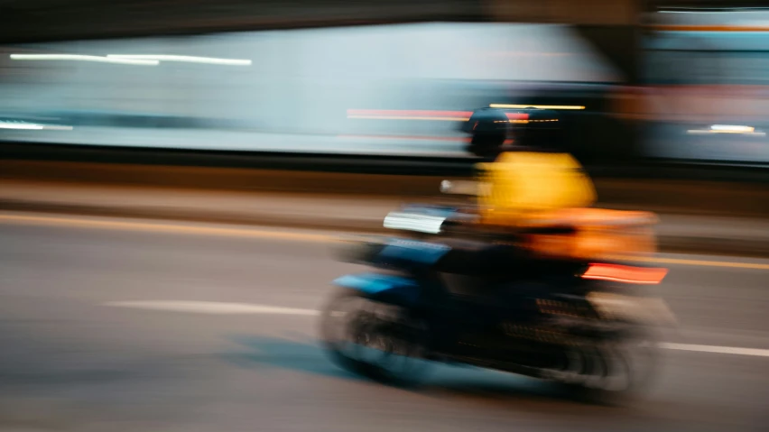 a motorcycle with some kind of yellow and orange bag on it