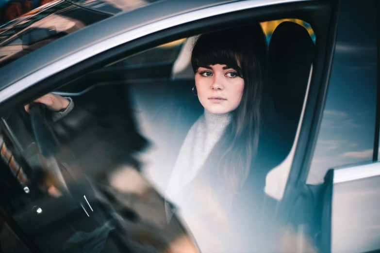 a woman sitting in the passenger seat of a car