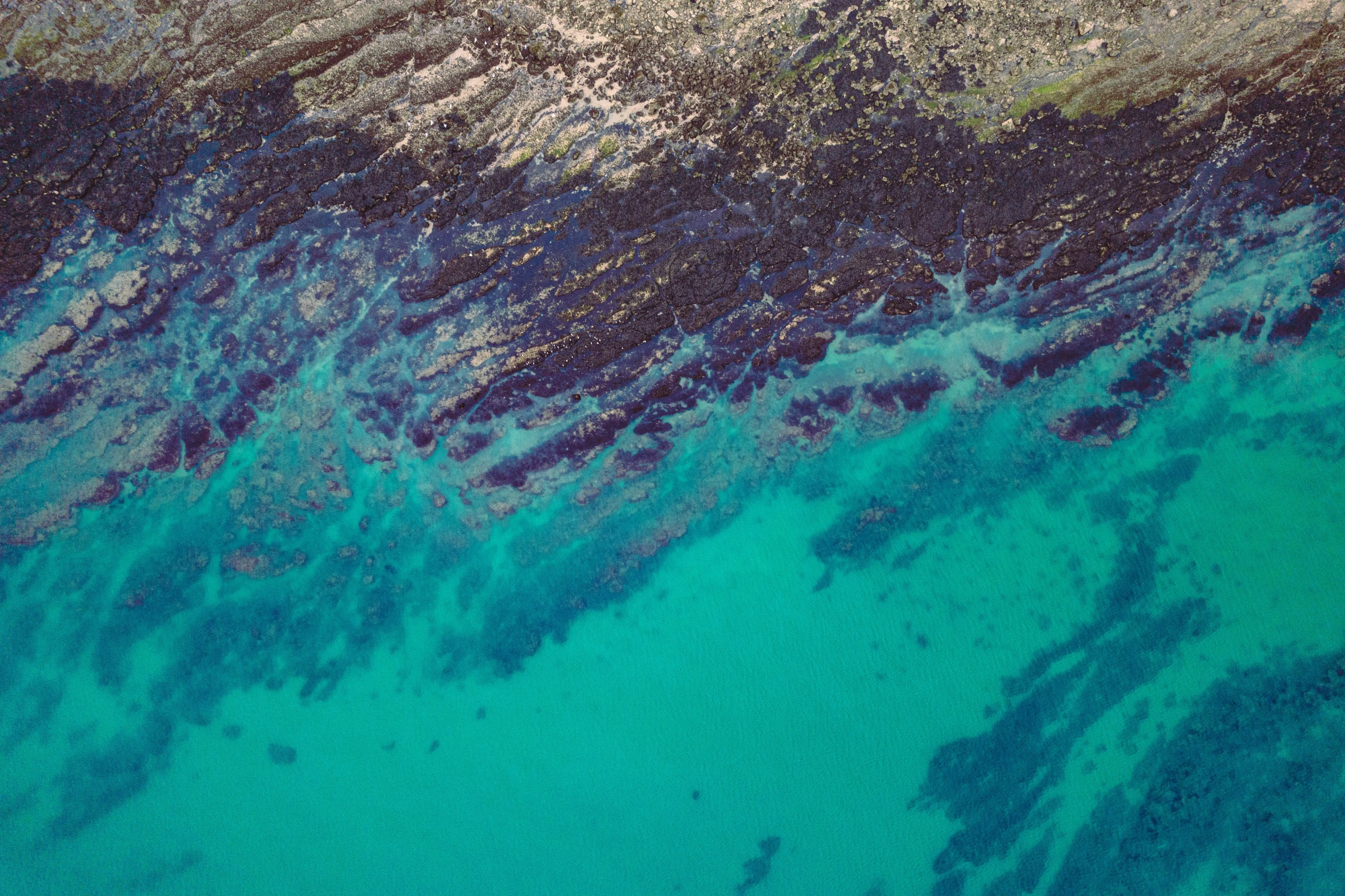 a blue ocean and a yellow one is shown from above