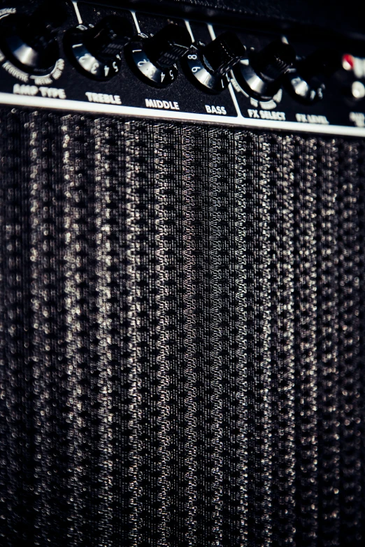 some black and white strings on the back of an amp