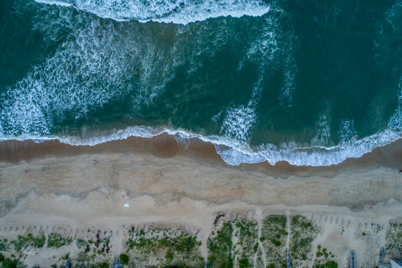 an aerial view of a sandy beach and the ocean