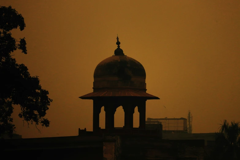 a bell and dome sits atop a small tower