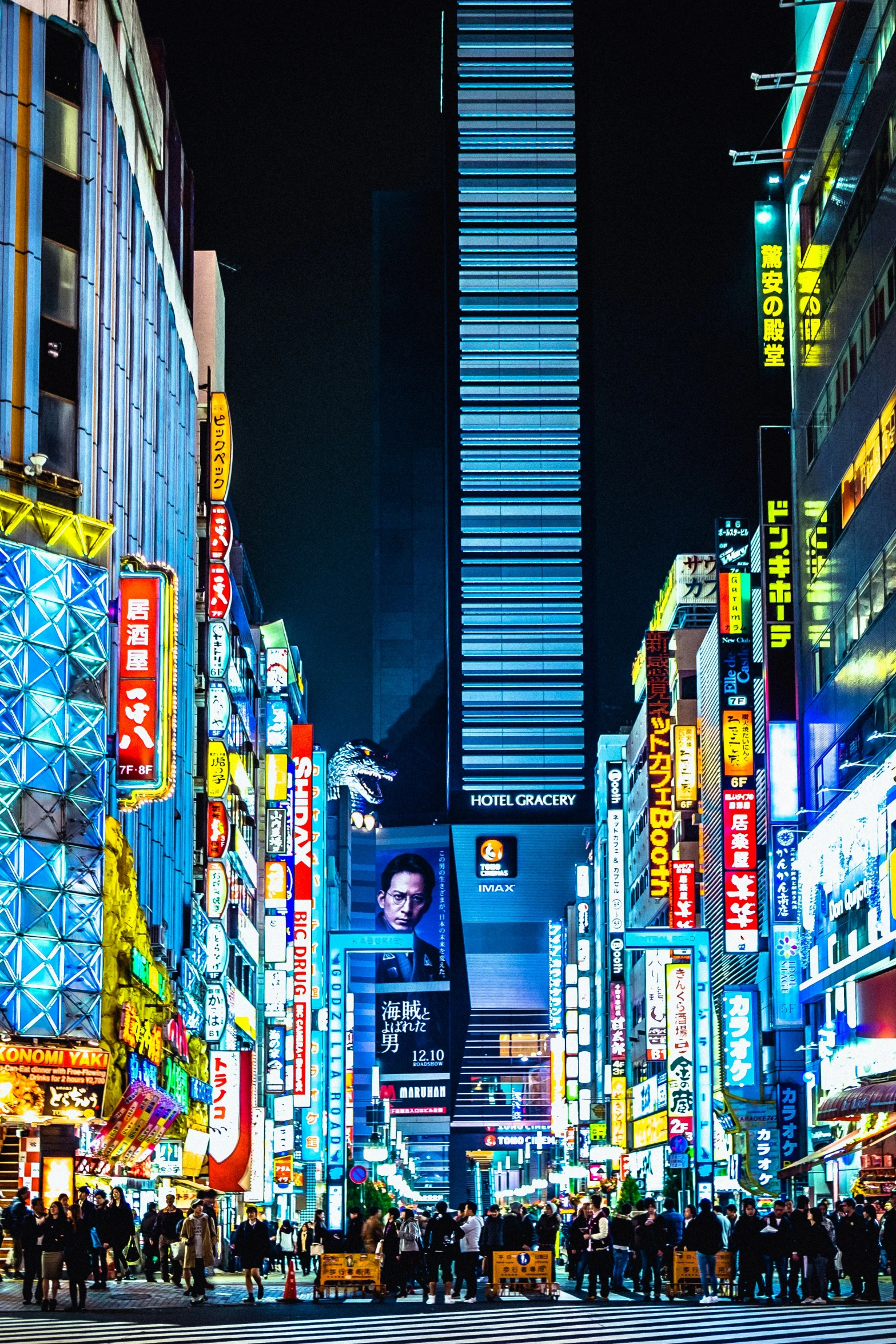 a city street with skyscrs and many lights at night