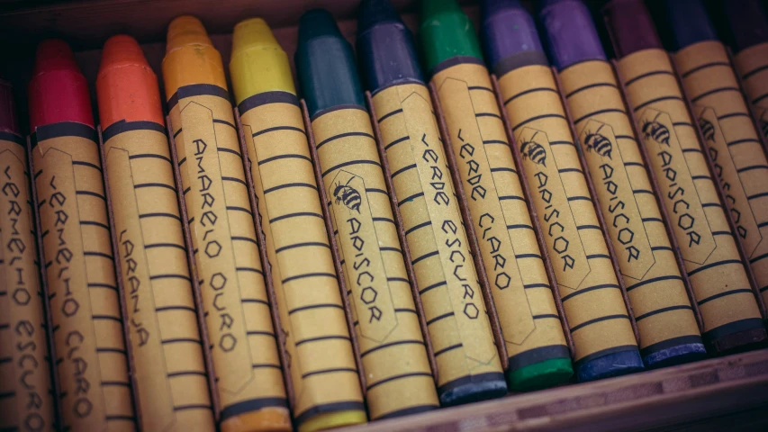 a box with pencils filled with different color of crayons