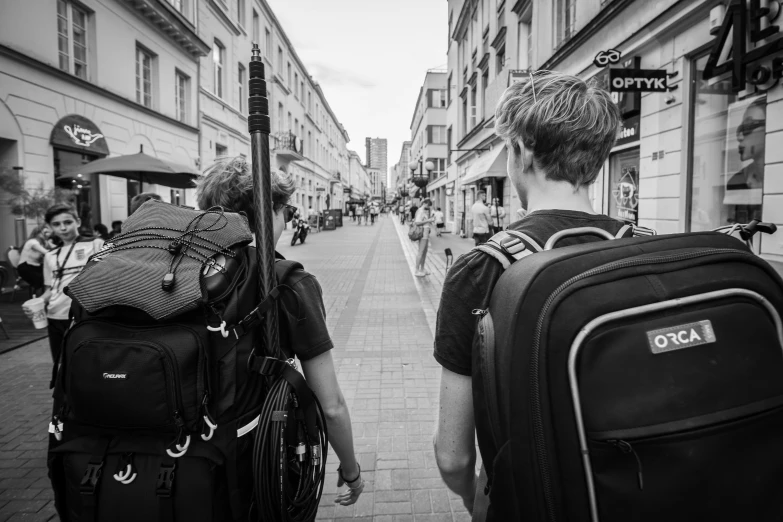 a black and white image of people walking down the street