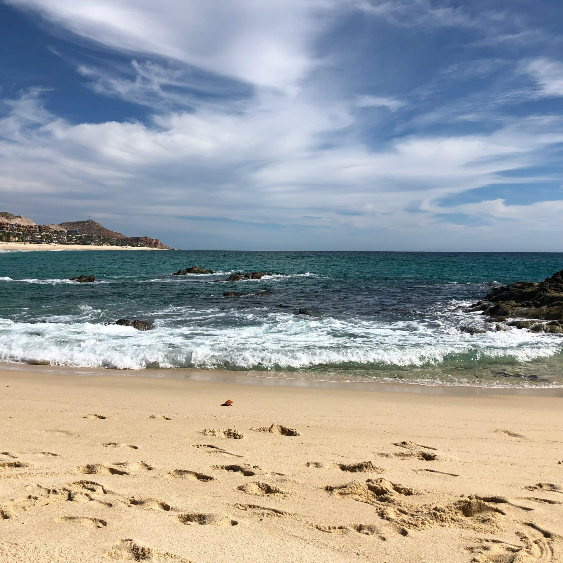 a beach filled with lots of water and sandy shore